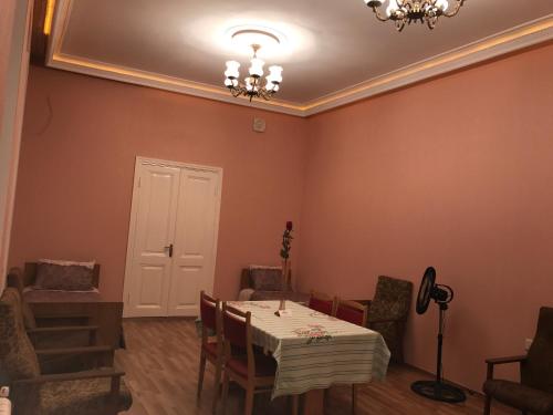 a dining room with a table and chairs at Beaming_House in Sheki