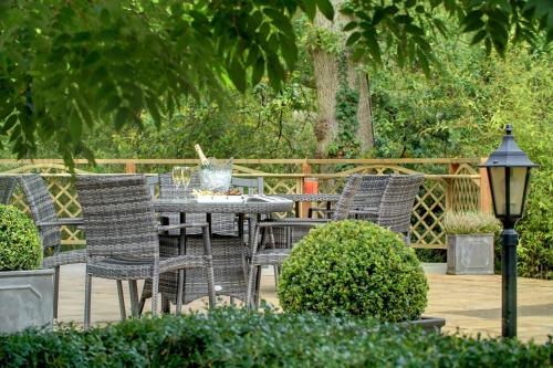 a patio with a table and chairs and a lamp at Ivy Hill Hotel, Sure Hotel Collection by Best Western in Chelmsford