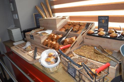a bakery with boxes of pastries on a counter at ibis Rennes Cesson in Cesson-Sévigné