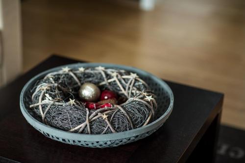 a bowl with a nest on top of a table at Acco Luxury Apartments in Akureyri
