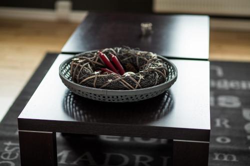 a bowl with red pencils in it sitting on a table at Acco Luxury Apartments in Akureyri