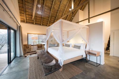 a bedroom with a bed with a canopy at Unembeza Boutique Lodge & Spa in Hoedspruit