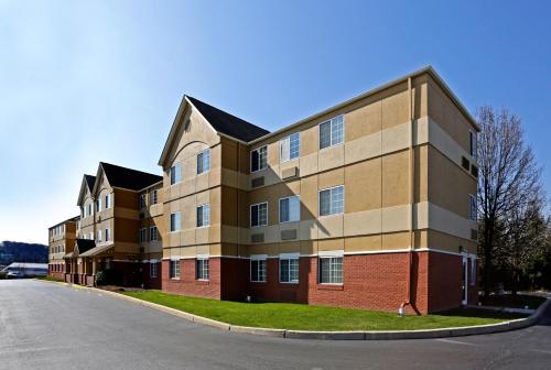 a large brick building on the side of a street at Extended Stay America Suites - Philadelphia - Malvern - Swedesford Rd in Malvern