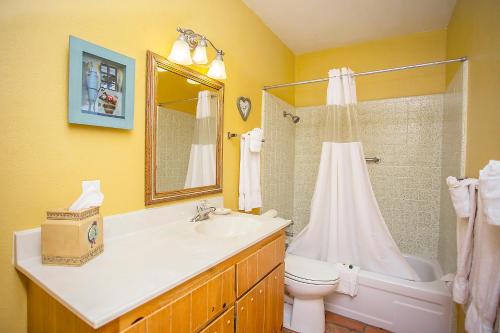 a bathroom with a sink and a toilet and a shower at My Place Suites in Wickenburg