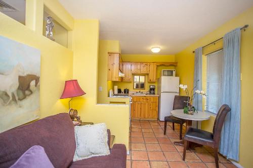 a living room with a couch and a table and a kitchen at My Place Suites in Wickenburg