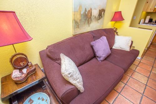 a brown couch in a living room with a lamp at My Place Suites in Wickenburg