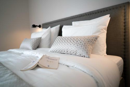 a white bed with a book on top of it at Domaine de Saint Clair in Aix-en-Provence