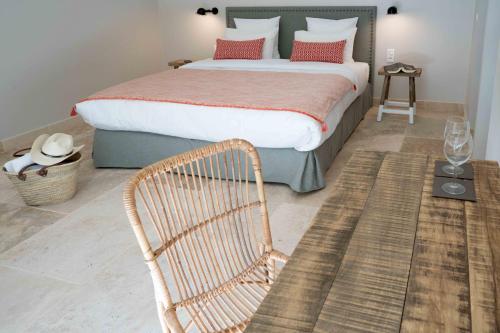 a bedroom with a large bed and a chair at Domaine de Saint Clair in Aix-en-Provence