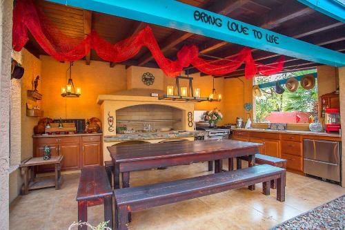 a large kitchen with a table and benches in it at My Place Suites in Wickenburg
