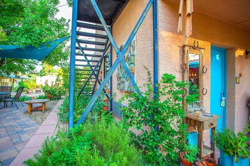 a house with a blue door and a patio with plants at My Place Suites in Wickenburg