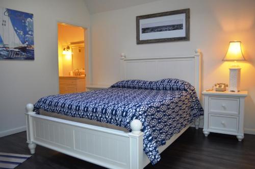 a bedroom with a bed with a blue comforter at Montauk Manor in Montauk