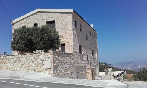 a stone building on the side of a road at Starlit Villa in Kathikas