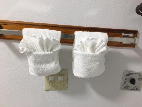 a pair of towels hanging on a towel rack at OceanView Motel in Huntington Beach