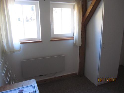 a bathroom with two windows and a bath tub at Horská Chata U Básníka in Horní Malá Úpa
