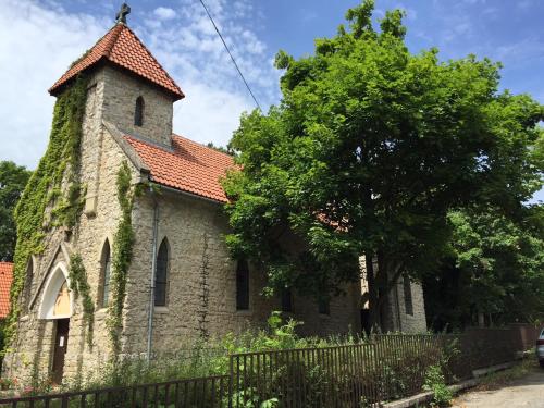an old church with a tree in front of it at Fövenyes House in Balatonudvari
