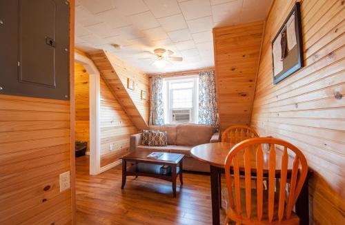 a living room with a couch and a table at Cavendish Lodge & Cottages in Cavendish