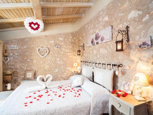 a bedroom with a bed with red flowers on it at La Casa Sul Lago in Posta Fibreno
