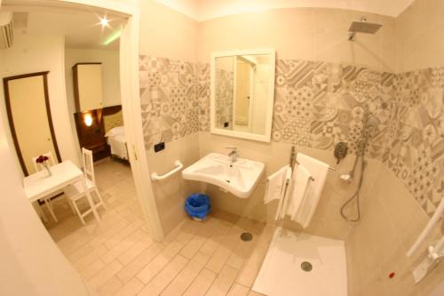 a bathroom with a sink and a mirror and a shower at Hotel Chic in SantʼAntimo