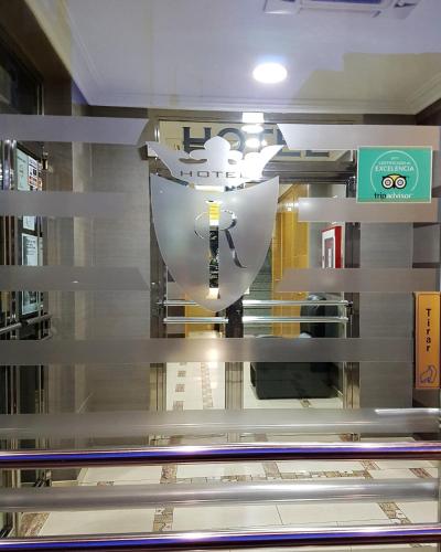 a reflection of a clock in a glass window at Hotel Reina Isabel in Medina del Campo