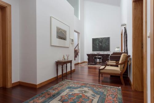 a living room with a chair and a table at 43 House Azores in Ponta Delgada