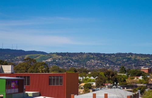 a view of a city with mountains in the background at The Palms Apartments in Adelaide