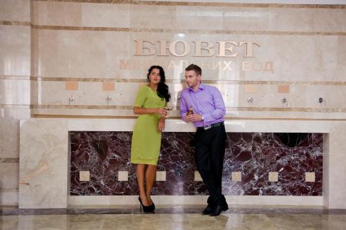 a man and a woman standing in front of a wall at Lisova Pisnia Resort Hotel in Truskavets