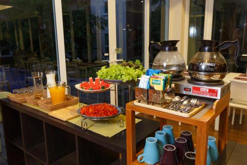 a table with a buffet of food and drinks at U Tiny Boutique Hotel Suvarnabhumi Bangkok - SHA Plus in Lat Krabang
