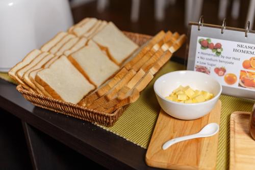 a table topped with bread and a bowl of butter at U Tiny Boutique Hotel Suvarnabhumi Bangkok - SHA Plus in Lat Krabang