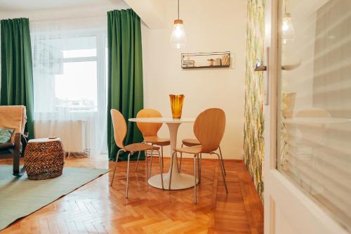 a dining room with a table and chairs at Old Town View Apartment in Bucharest