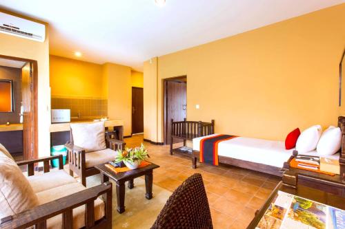 a hotel room with a bed and a living room at Temple Tree Resort & Spa, Pokhara in Pokhara