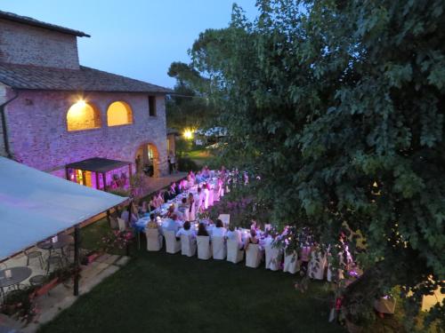 an overhead view of a wedding ceremony in front of a building at Il Baraccotto in Lucignano