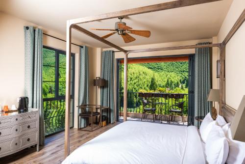 a bedroom with a bed and a balcony at Arcadia Resorts in Deqing