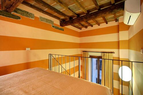 a room with orange and yellow stripes on the walls at Apartments Puccini in Florence