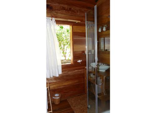 a bathroom with a shower and a sink at Lakaz An Bwa in La Digue
