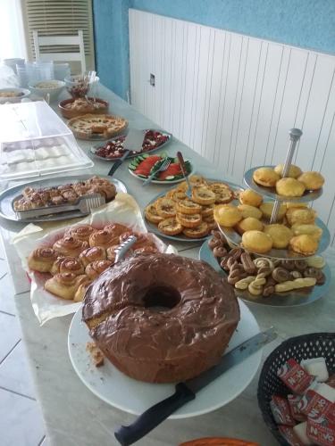 a table topped with lots of different types of donuts at Esperides Hotel in Myrtos