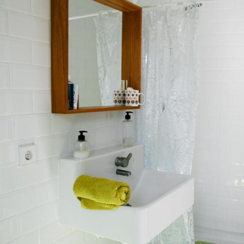 a bathroom sink with a yellow towel on it at Casa para tres hermanas in Bullas