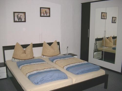 a bedroom with a large bed with a large mirror at Ferienwohnungen "Altes Bachhaus" in Eisenach