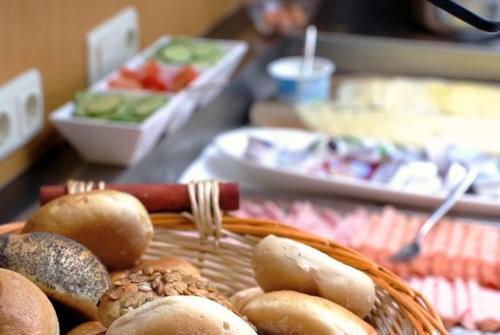 a basket of bagels and other food on a table at Hotel Nummerhof in Erding