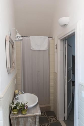 a bathroom with a sink and a shower at Masseria Luco in Martina Franca