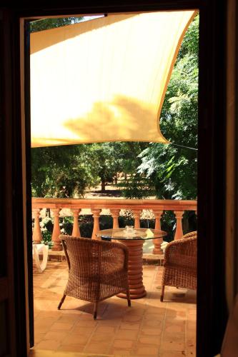 a view of a patio with chairs and a table at Petit Hotel Es Figueral in Campos