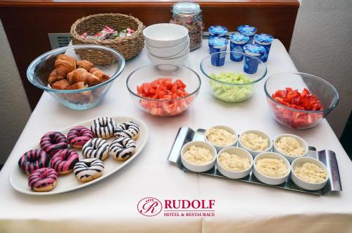 a table with bowls of food and other foods at Hotel Rudolf in Havířov