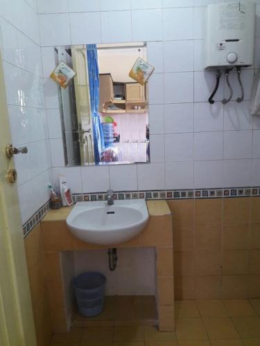 a bathroom with a sink and a mirror at Villa Kota Bunga NA2 in Puncak
