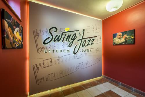a room with a sign on the wall with music notes at Tó Wellness Hotel in Bánk