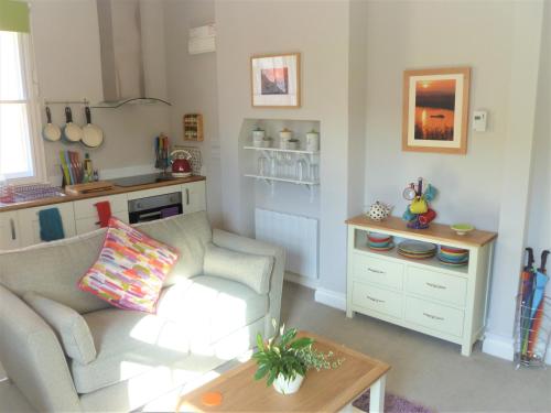 a living room with a couch and a table at Chalice Lodge in Glastonbury