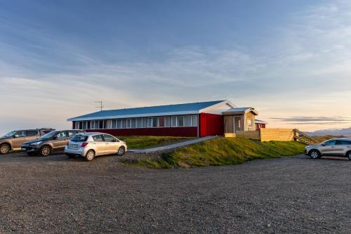 a group of cars parked in front of a building at Lilja Guesthouse in Höfn