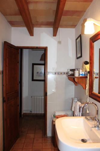 a bathroom with a sink and a mirror at Petit Hotel Es Figueral in Campos