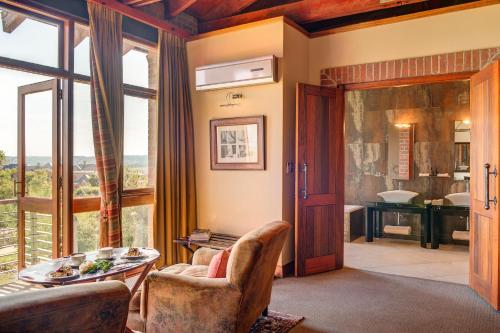 a living room with a view of a bathroom at Riboville Boutique Hotel And Restaurant in Midrand
