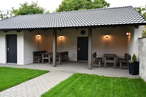 a pavilion with a table and chairs on a patio at Penzion U Hujňáků in Rohatec