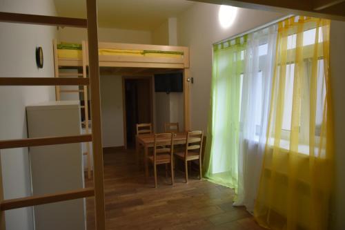 a room with a table and chairs and a dining room at Penzion U Hujňáků in Rohatec