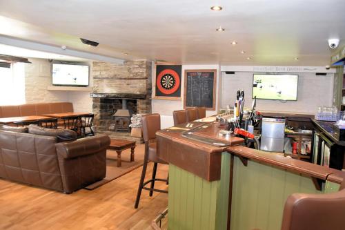 a living room with a bar and a restaurant at The Red Lion in Cardigan